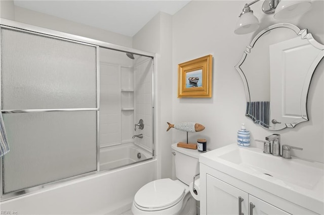 bathroom featuring enclosed tub / shower combo, vanity, and toilet