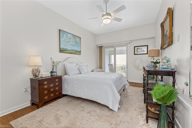 bedroom with baseboards, ceiling fan, wood finished floors, and access to exterior