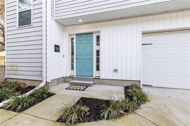 view of exterior entry featuring an attached garage