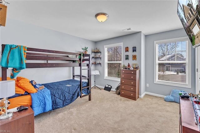 bedroom with light carpet, visible vents, and baseboards