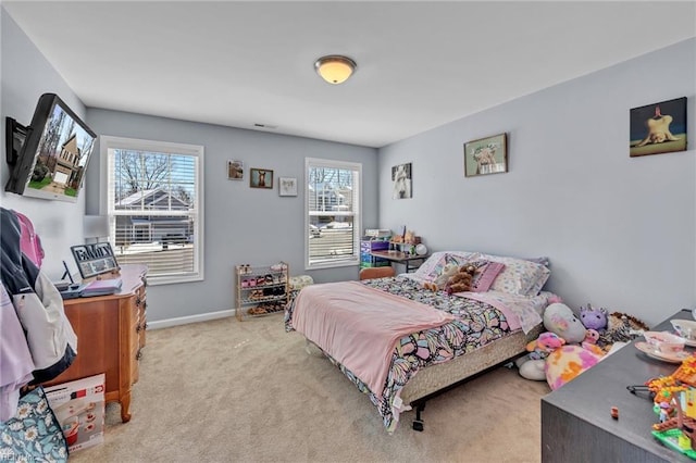 bedroom with light colored carpet and baseboards