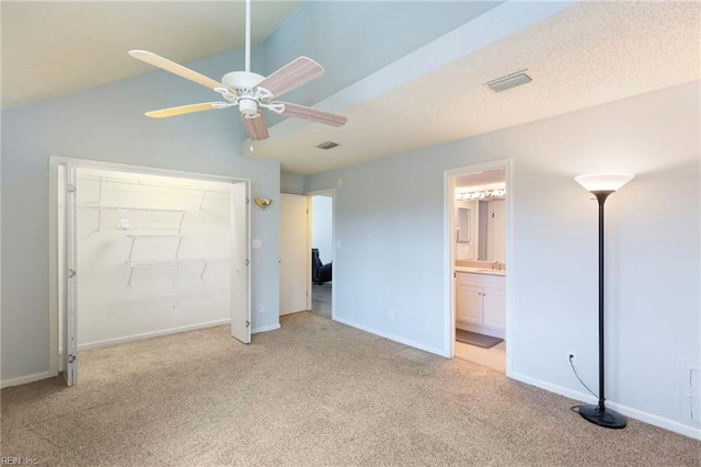 unfurnished bedroom featuring light colored carpet, a sink, visible vents, baseboards, and a closet