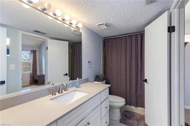 full bath featuring visible vents, toilet, vanity, and a textured ceiling