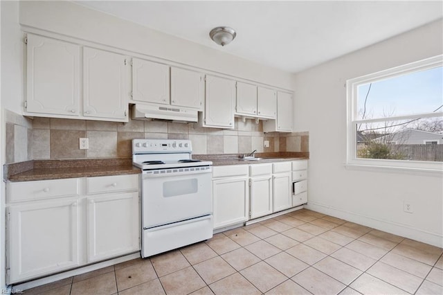 kitchen with decorative backsplash, dark countertops, white electric range, under cabinet range hood, and white cabinetry