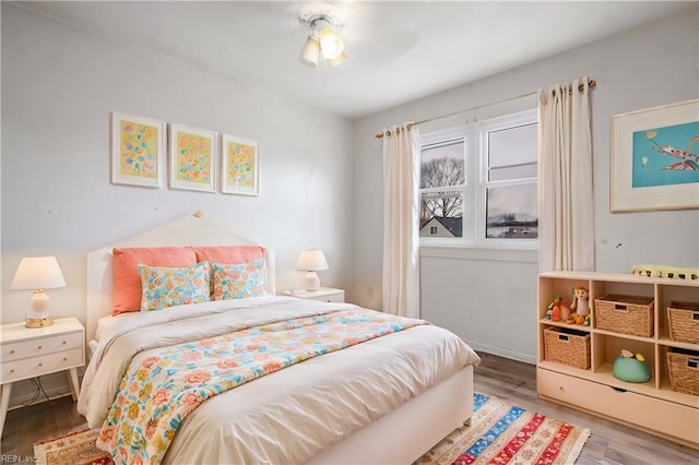 bedroom featuring wood finished floors and a ceiling fan