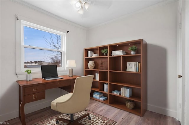 office space featuring ornamental molding, baseboards, and light wood finished floors