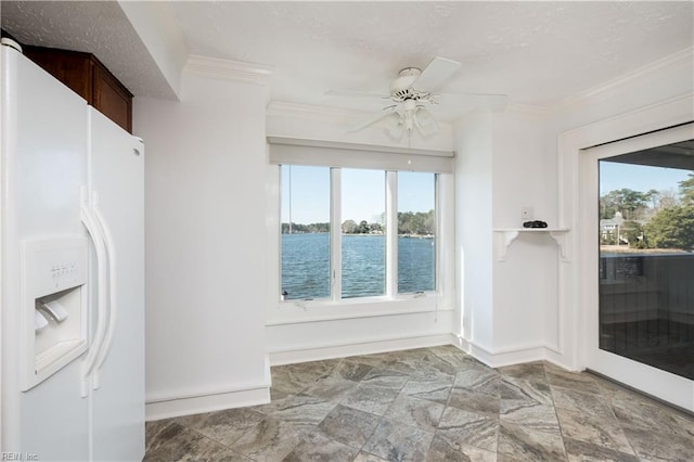 interior space featuring a water view and ceiling fan