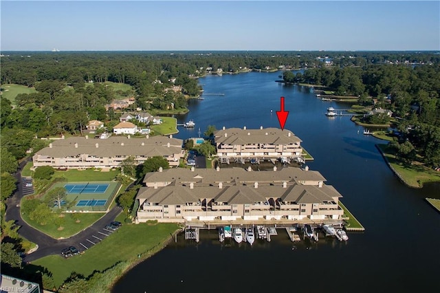 aerial view featuring a water view, a wooded view, and a residential view