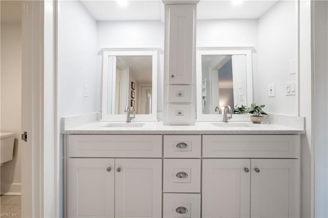 full bathroom with double vanity and a sink