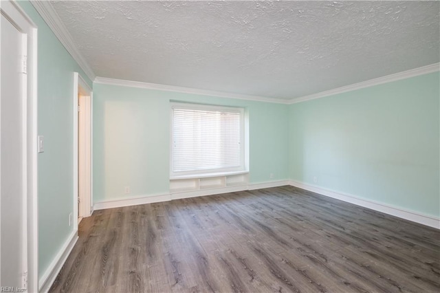 empty room featuring baseboards, ornamental molding, dark wood finished floors, and a textured ceiling