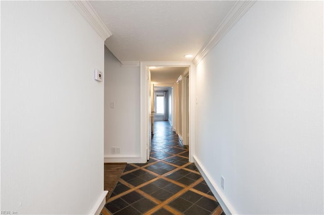 corridor featuring crown molding and baseboards