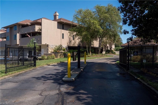 view of road with a residential view and curbs