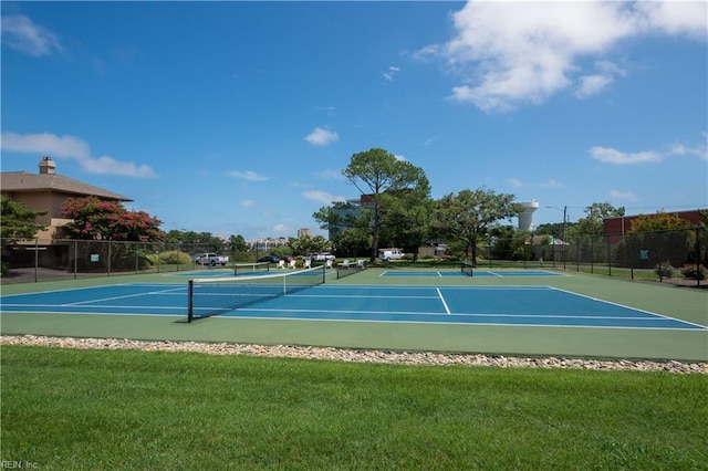 view of sport court featuring a yard and fence