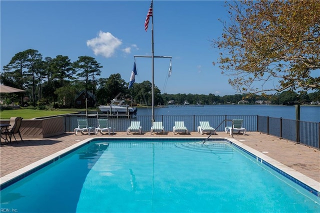 pool with a water view and a patio