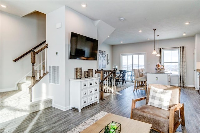 living area featuring baseboards, visible vents, dark wood-style floors, stairway, and recessed lighting