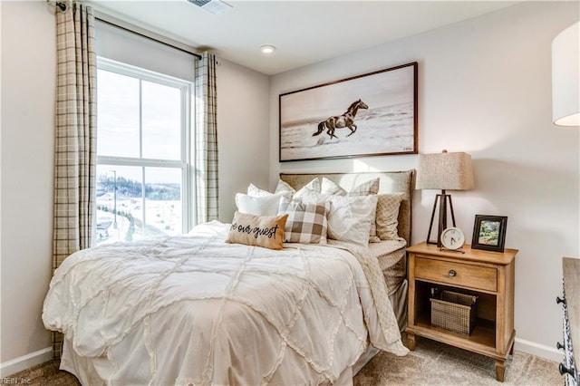 carpeted bedroom with visible vents and baseboards