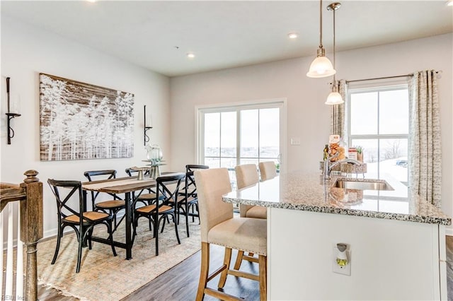 dining area featuring dark wood-type flooring and recessed lighting