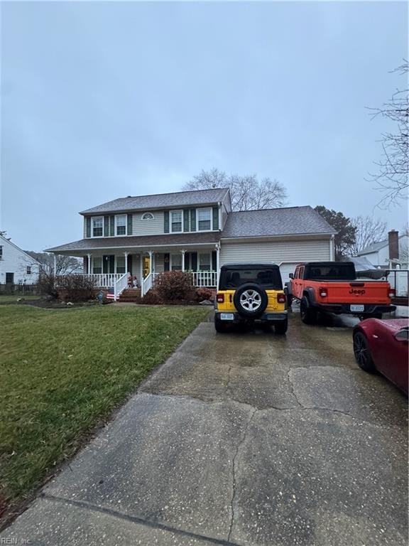 view of front facade with covered porch, driveway, a front lawn, and a garage