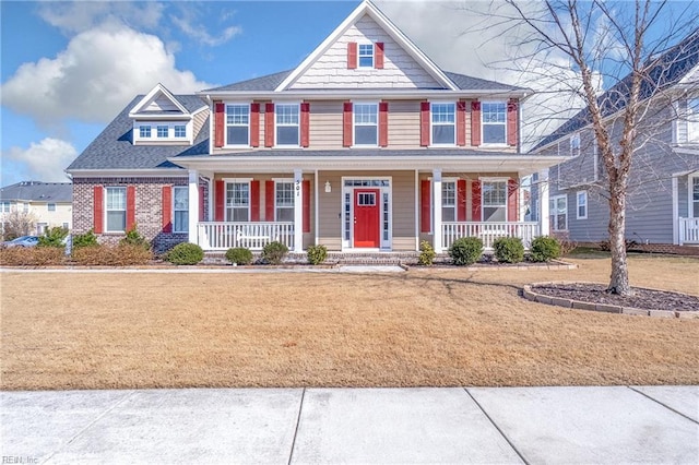 view of front of home with a porch and brick siding