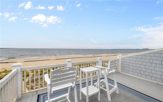 exterior space featuring a water view and a view of the beach