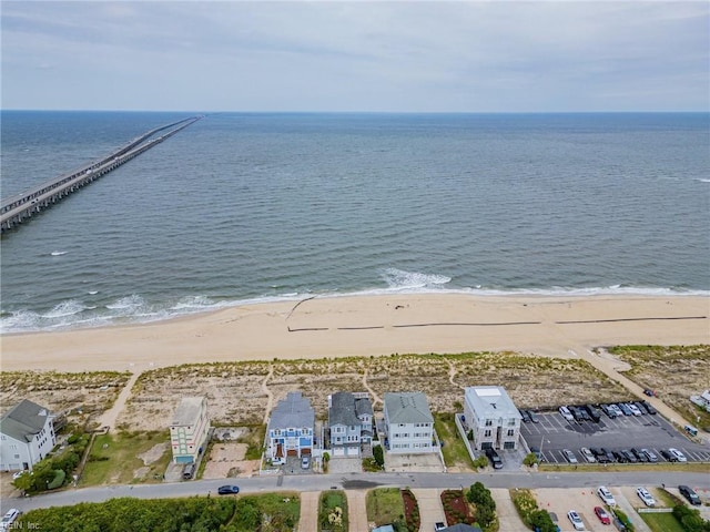 drone / aerial view featuring a water view and a view of the beach