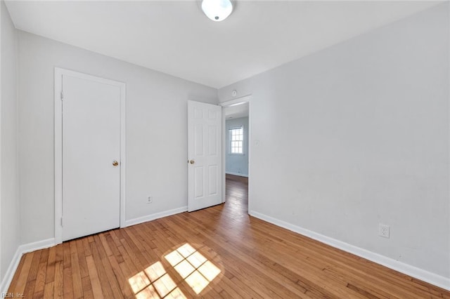 unfurnished bedroom featuring light wood finished floors and baseboards