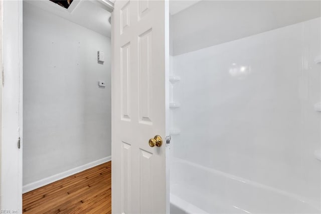 interior space with wood finished floors and baseboards