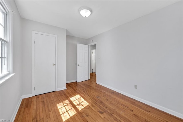 unfurnished bedroom with light wood-type flooring and baseboards