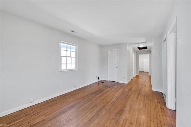 unfurnished room with baseboards, visible vents, and light wood-style floors