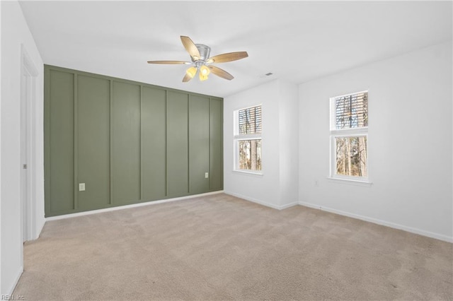 unfurnished room featuring light carpet and ceiling fan