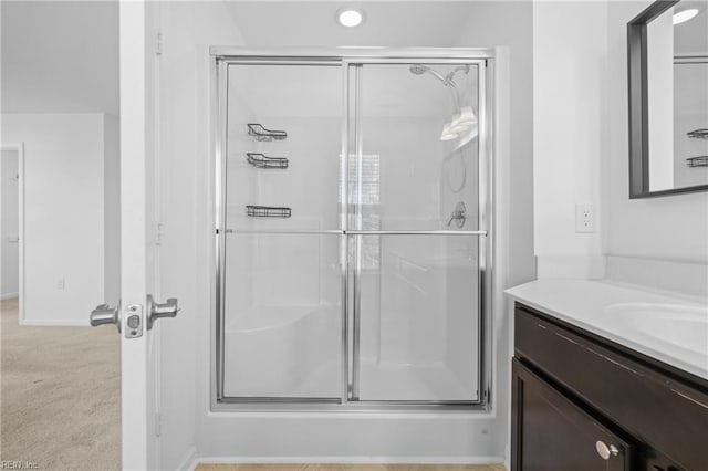 full bath with a shower stall and vanity