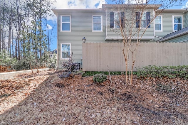 rear view of house featuring fence