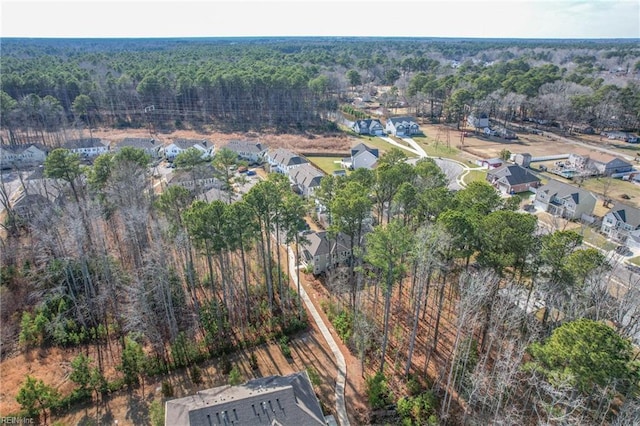 birds eye view of property with a residential view and a wooded view