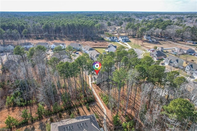 drone / aerial view featuring a residential view and a view of trees