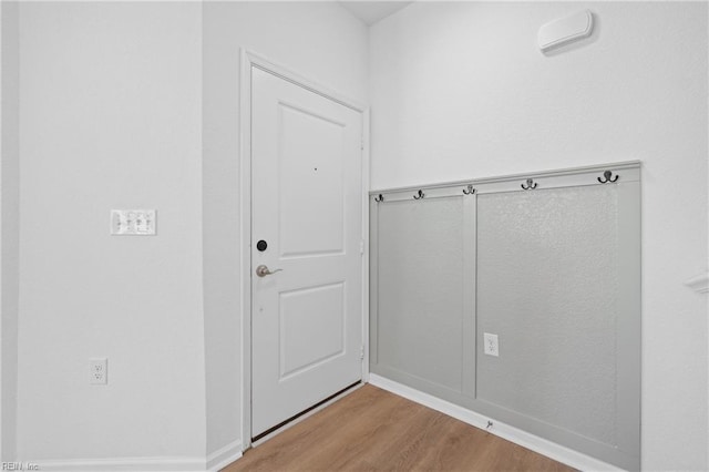 mudroom with light wood-style floors and baseboards