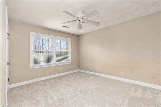 empty room featuring light carpet, baseboards, and visible vents