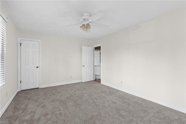 unfurnished bedroom featuring carpet, baseboards, and a ceiling fan