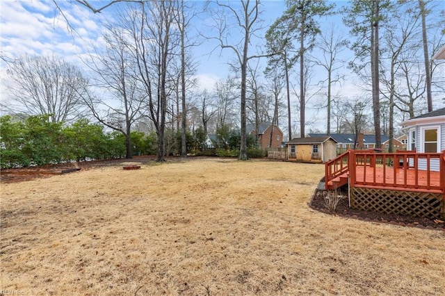 view of yard featuring an outbuilding and a wooden deck