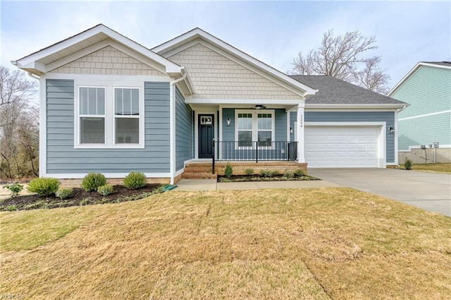 view of front facade with a garage, covered porch, driveway, and a front lawn