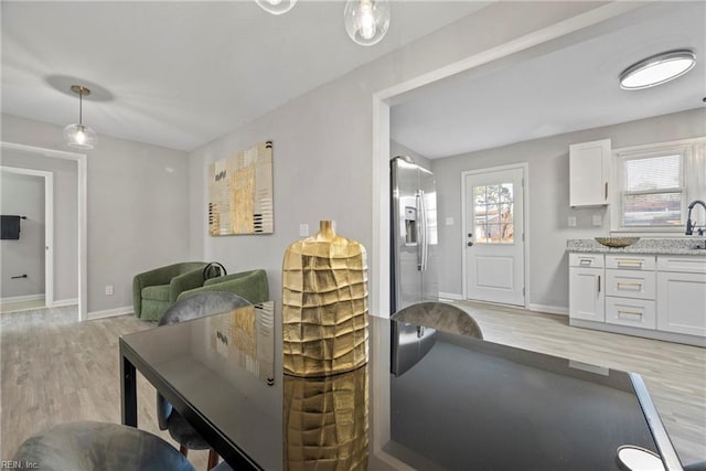 living room featuring light wood-style floors and baseboards