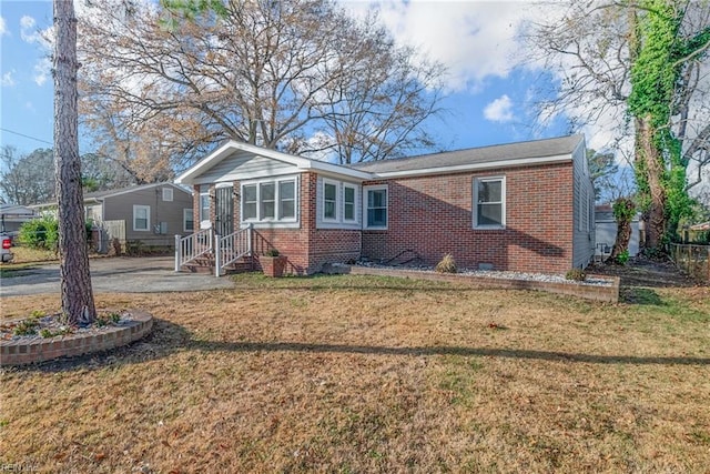 view of front of house featuring a front yard and brick siding