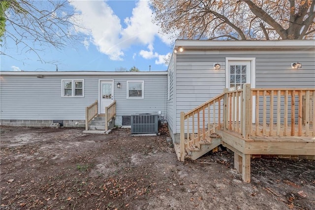 rear view of house with entry steps and cooling unit