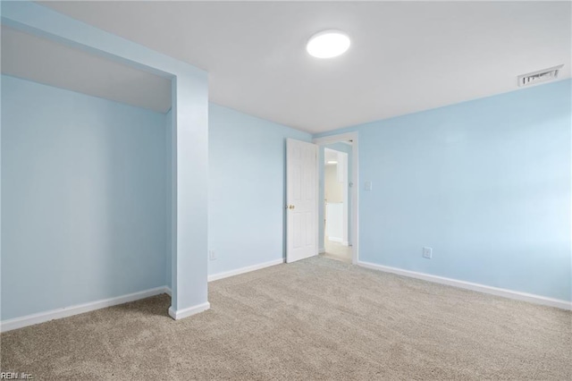 interior space featuring baseboards, visible vents, and light colored carpet