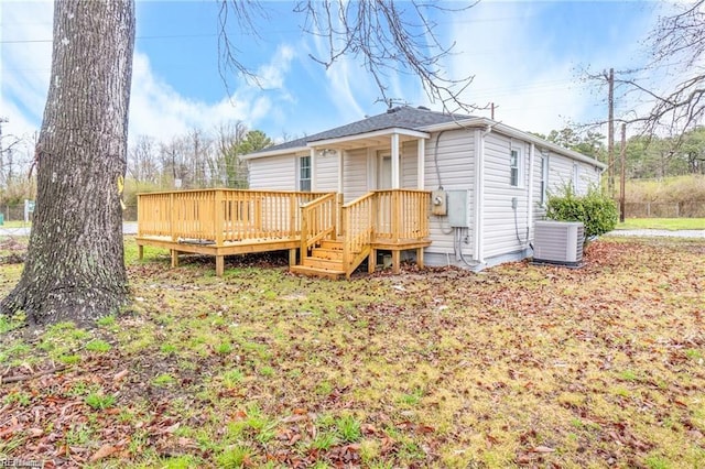 back of house with cooling unit and a wooden deck