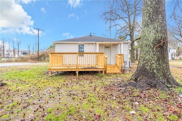 back of property featuring a wooden deck