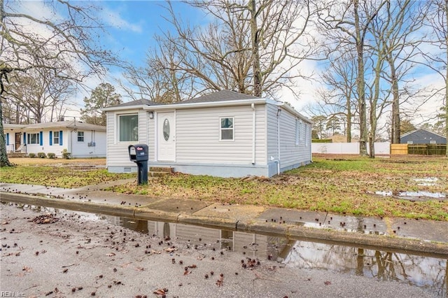 bungalow-style house with fence