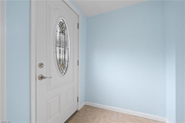 entryway featuring baseboards and light tile patterned floors