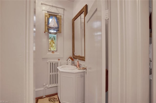 bathroom with radiator and vanity