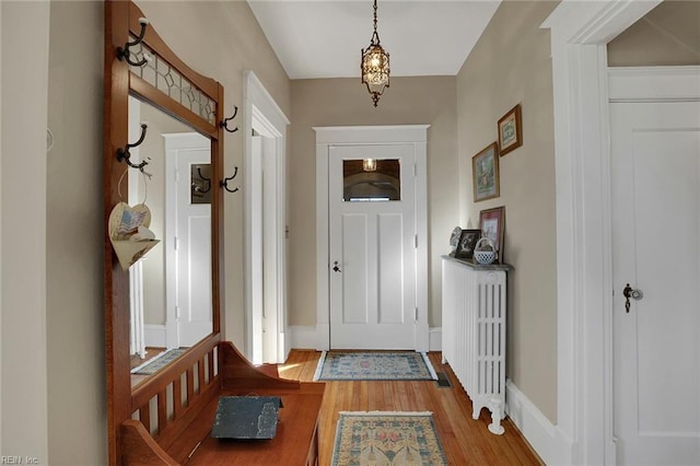 doorway to outside featuring light wood-style floors and baseboards