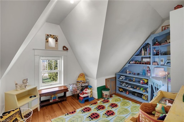 recreation room featuring vaulted ceiling and wood finished floors